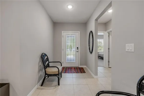 a living room with furniture and a lamp