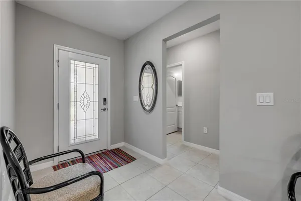 a living room with furniture and a lamp