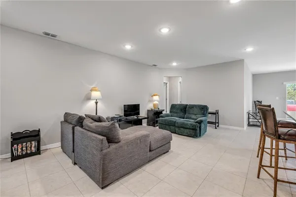 a living room with furniture and kitchen view