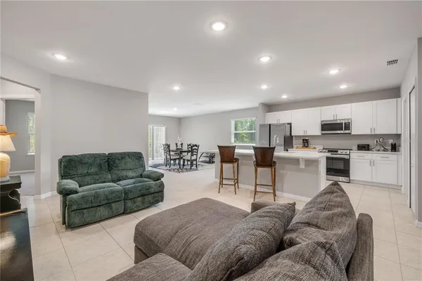 a kitchen with sink a microwave and cabinets