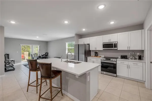 a kitchen with a sink stove and refrigerator