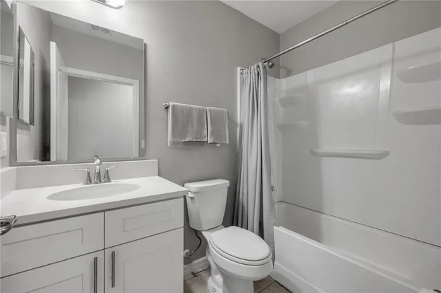 a living room with furniture and a lamp