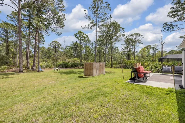a view of a floor to ceiling window and a yard