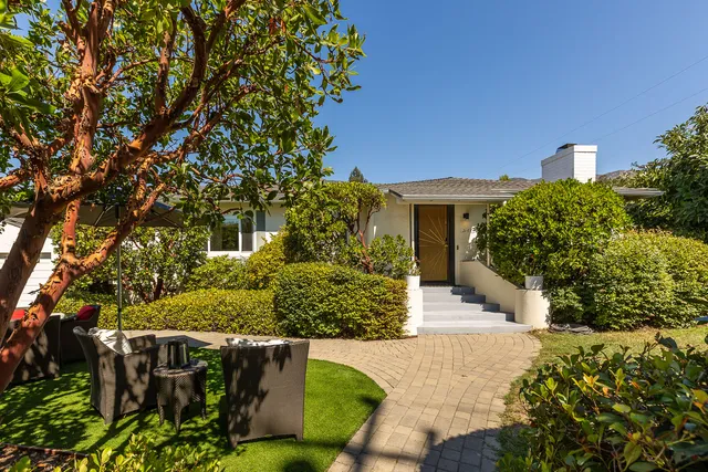 a front view of a house with a yard