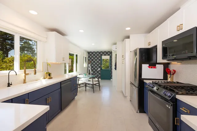 a kitchen with a sink stainless steel appliances and cabinets
