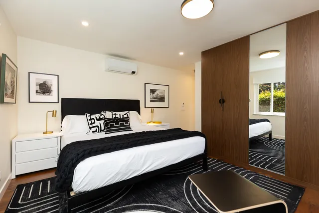 a bedroom with a bed and a chair