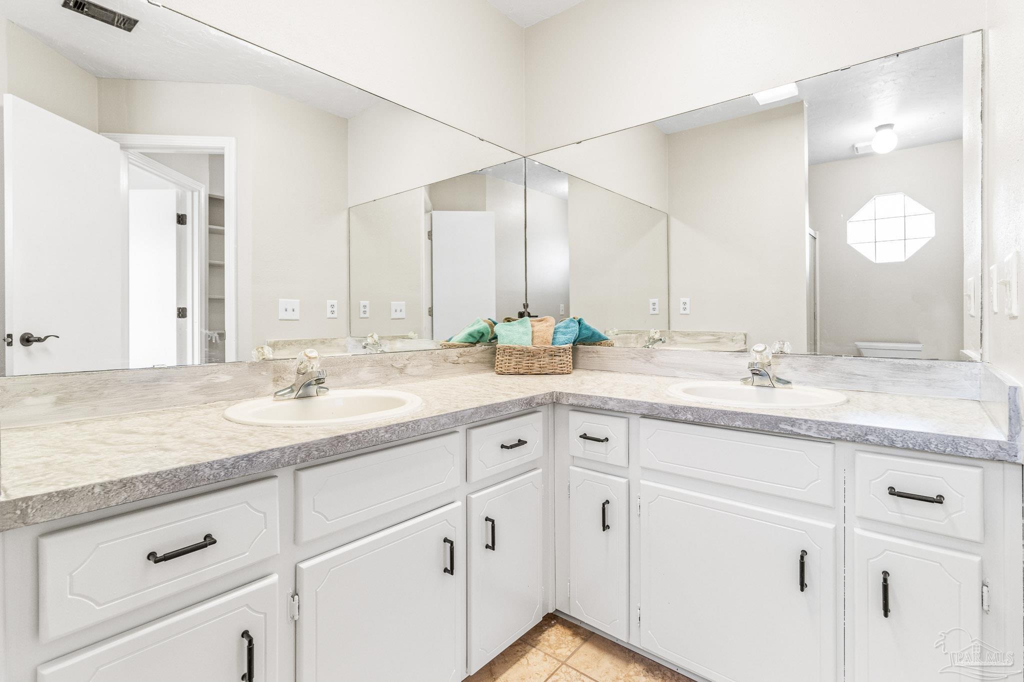 1655 Eagle Terrace Cantonment, FL 32533 - Photo 20 of 47 a bathroom with double sink and a mirror