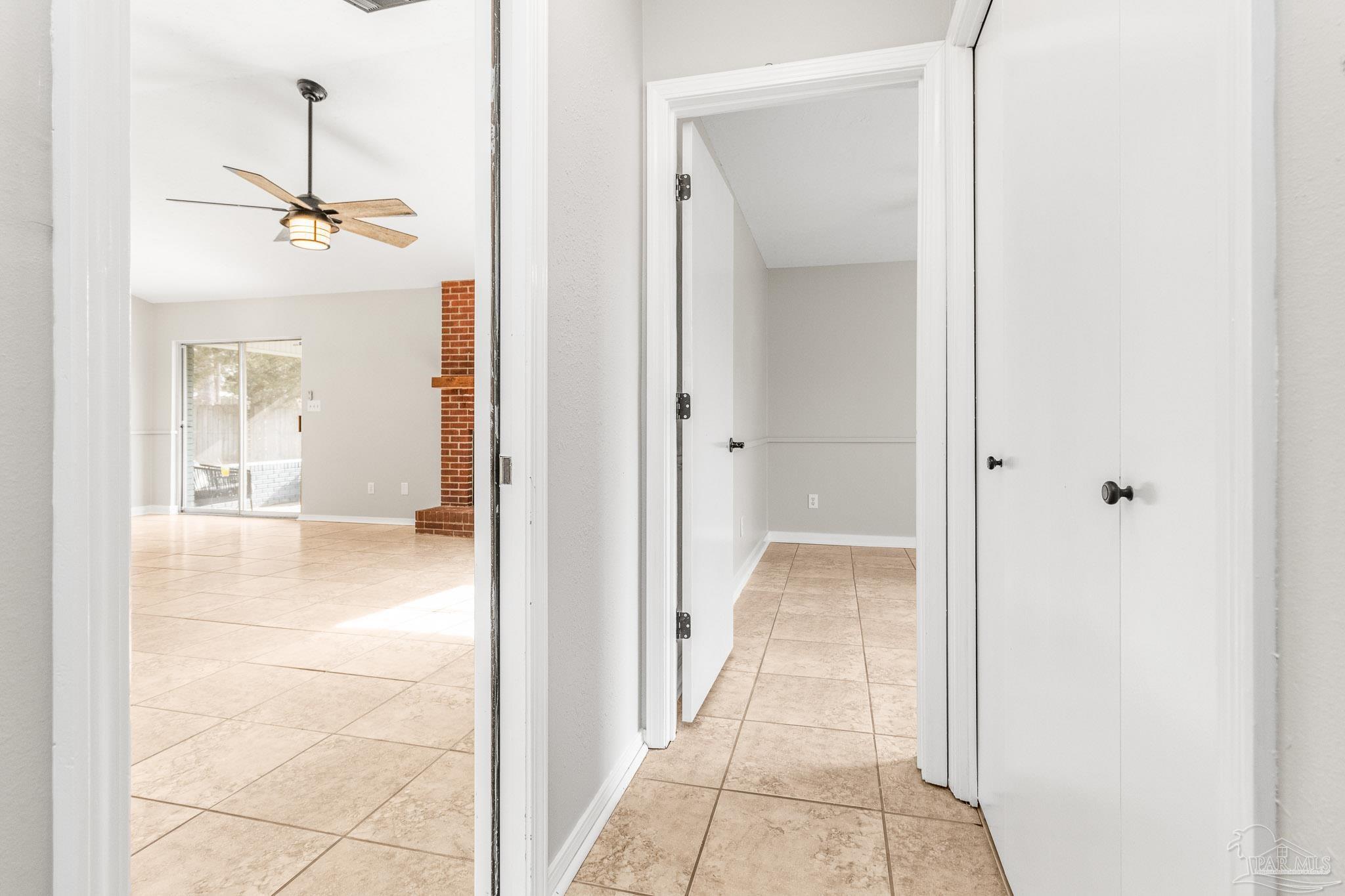 1655 Eagle Terrace Cantonment, FL 32533 - Photo 21 of 47 a view of a hallway with a chandelier fan and dining room view