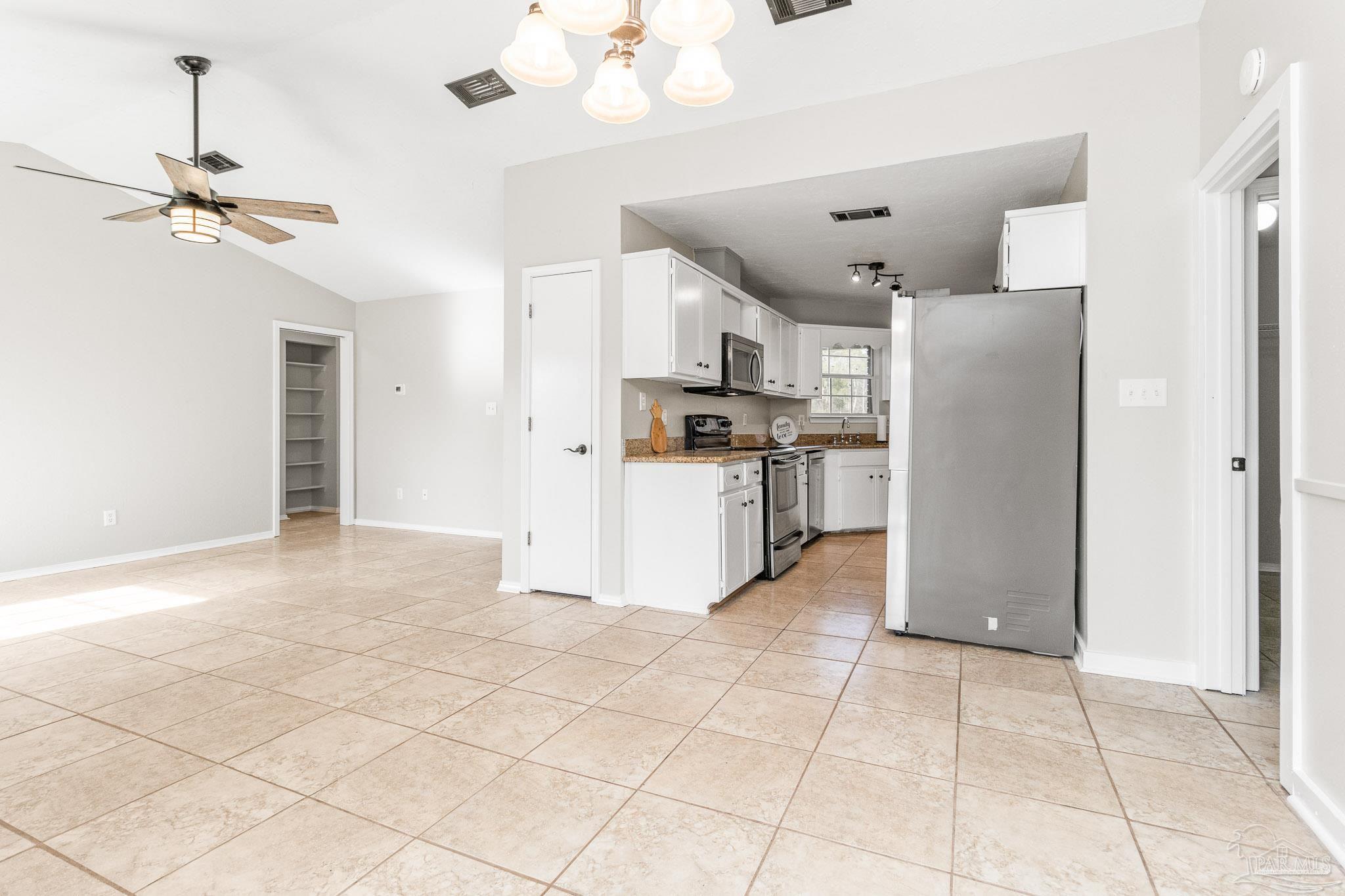 1655 Eagle Terrace Cantonment, FL 32533 - Photo 25 of 47 a view of a kitchen with a refrigerator and a microwave