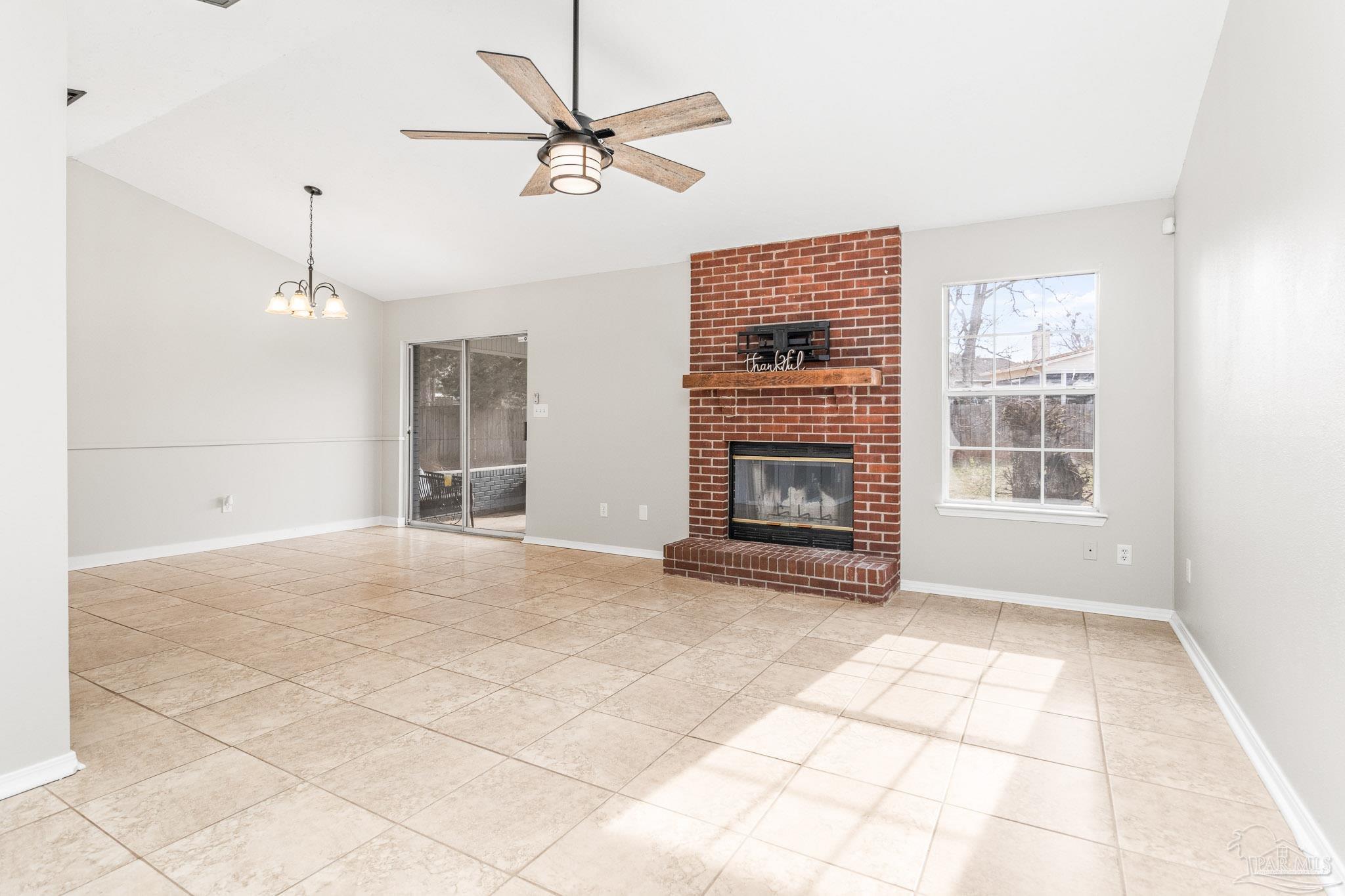 1655 Eagle Terrace Cantonment, FL 32533 - Photo 6 of 47 a view of an empty room with a fireplace and a window