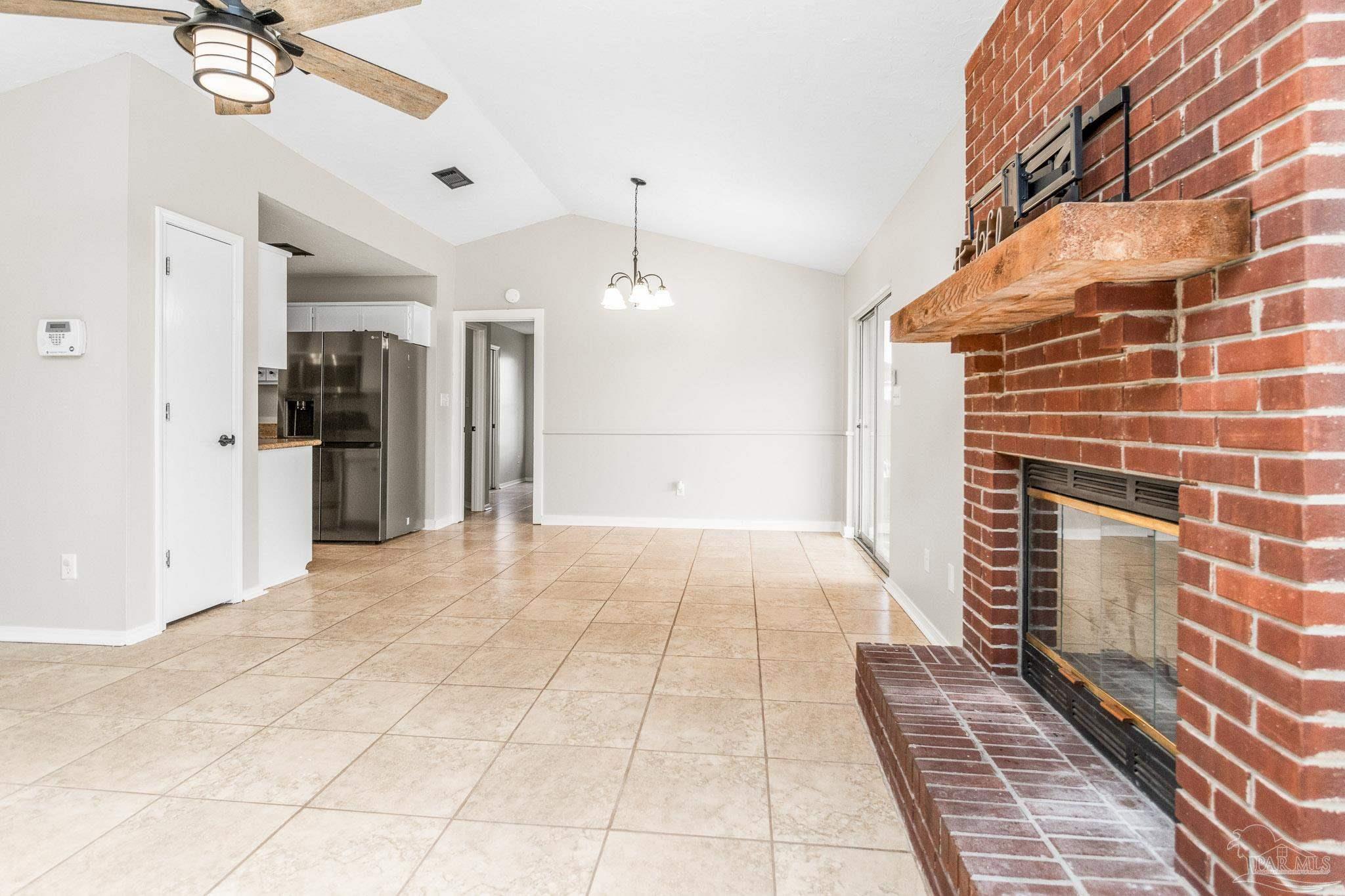 1655 Eagle Terrace Cantonment, FL 32533 - Photo 7 of 47 a view of a hallway with wooden floor and a chandelier