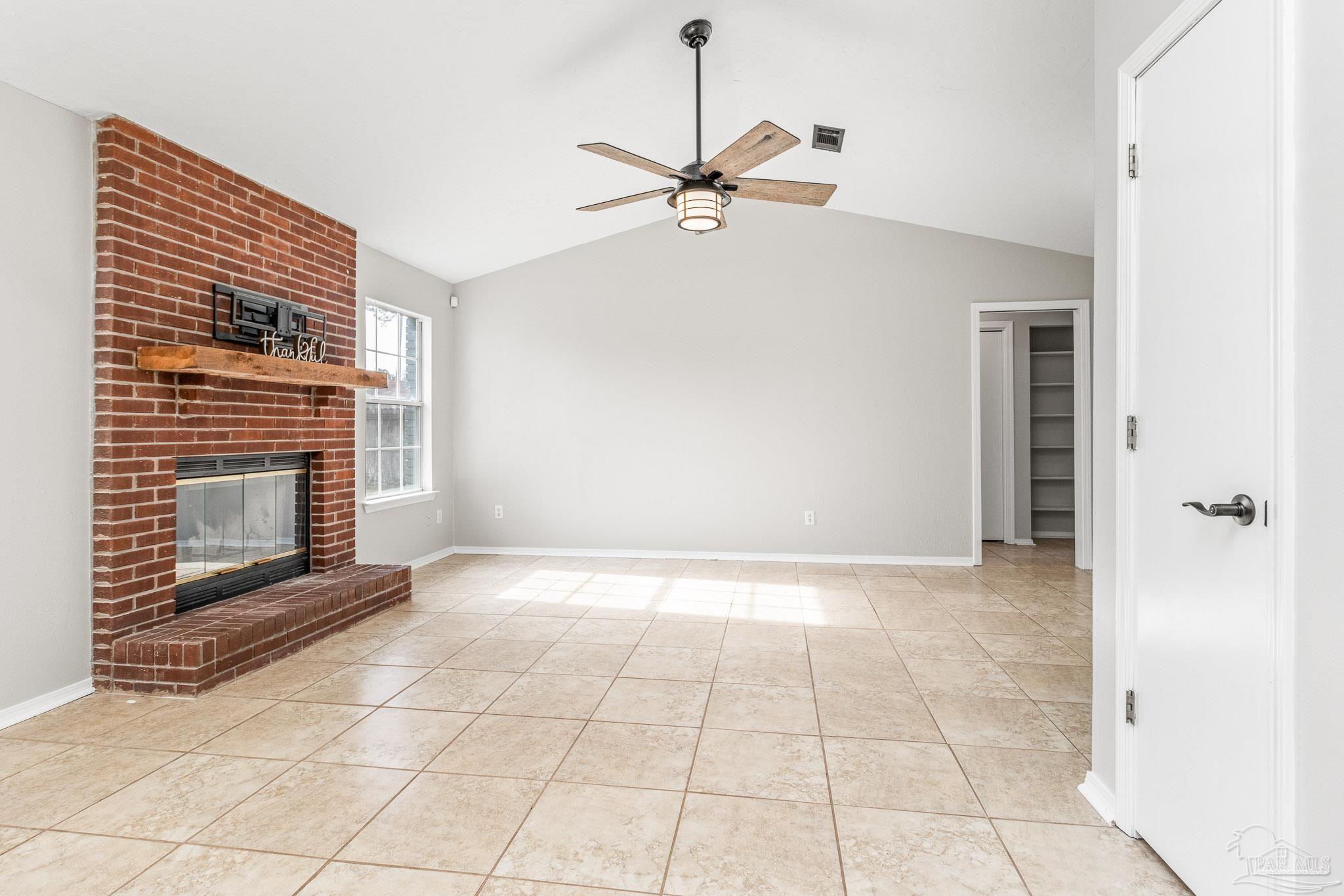 1655 Eagle Terrace Cantonment, FL 32533 - Photo 9 of 47 a view of an empty room with a fireplace and a window