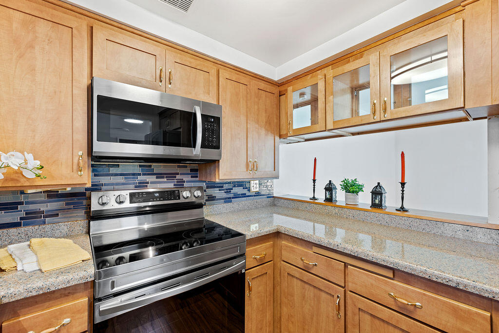 5722 Encina Road, Unit 2 Goleta, CA 93117 - Photo 8 of 21 a kitchen with stainless steel appliances a stove microwave and cabinets