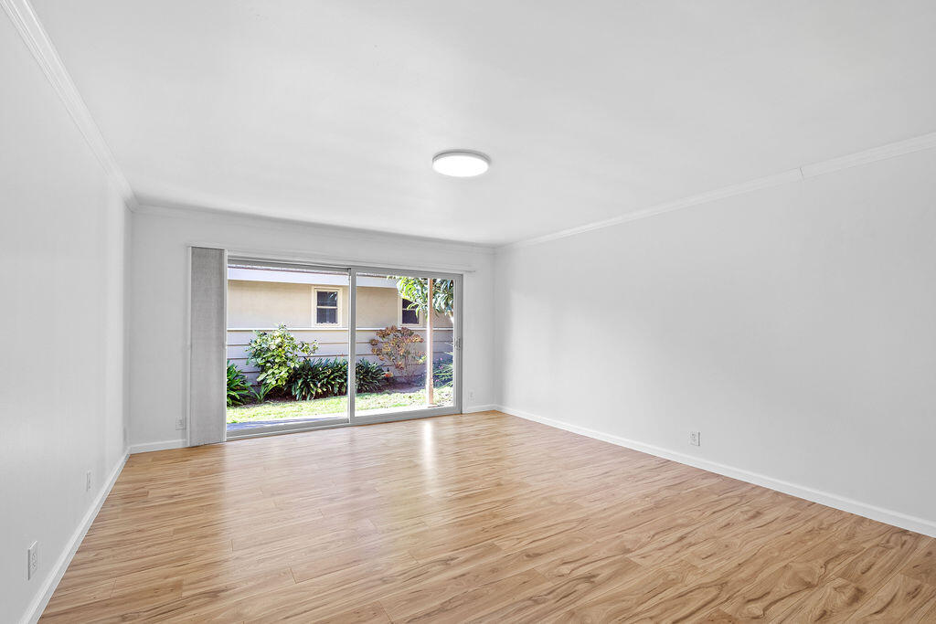 5722 Encina Road, Unit 2 Goleta, CA 93117 - Photo 9 of 21 a view of an empty room with wooden floor and a window