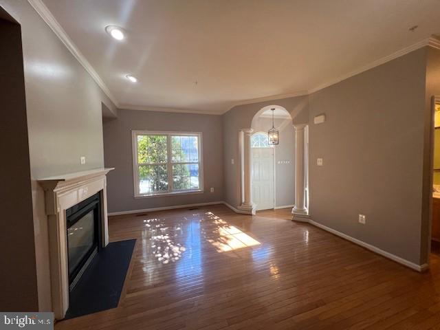 2622 Mill Race Road Frederick, MD 21701 - Photo 3 of 23 an empty room with wooden floor fireplace and windows