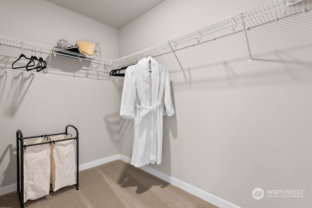 4426 228th Place South East, Unit MC2 Bothell, WA 98021 - Photo 23 of 30 a view of walk in closet with clothes and shoes