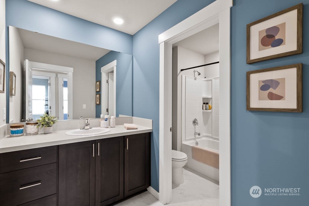 4426 228th Place South East, Unit MC2 Bothell, WA 98021 - Photo 26 of 30 a bathroom with a double vanity sink and a mirror