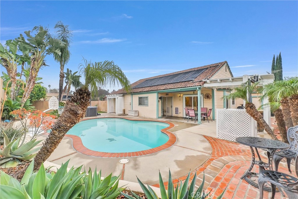 a view of house with swimming pool outdoor seating