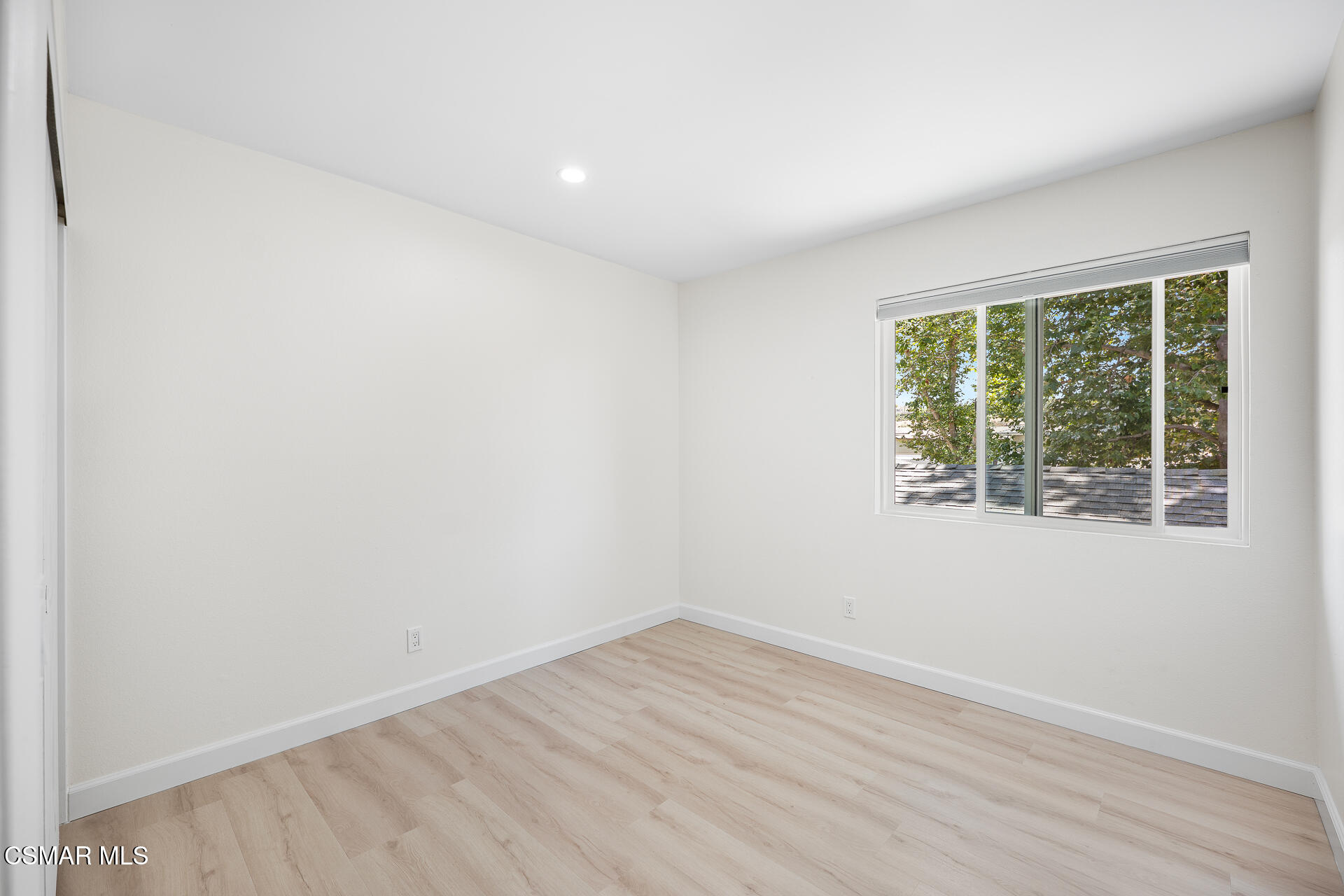 577 Spring Road, Unit 54 Moorpark, CA 93021 - Photo 18 of 23 an empty room with wooden floor and windows