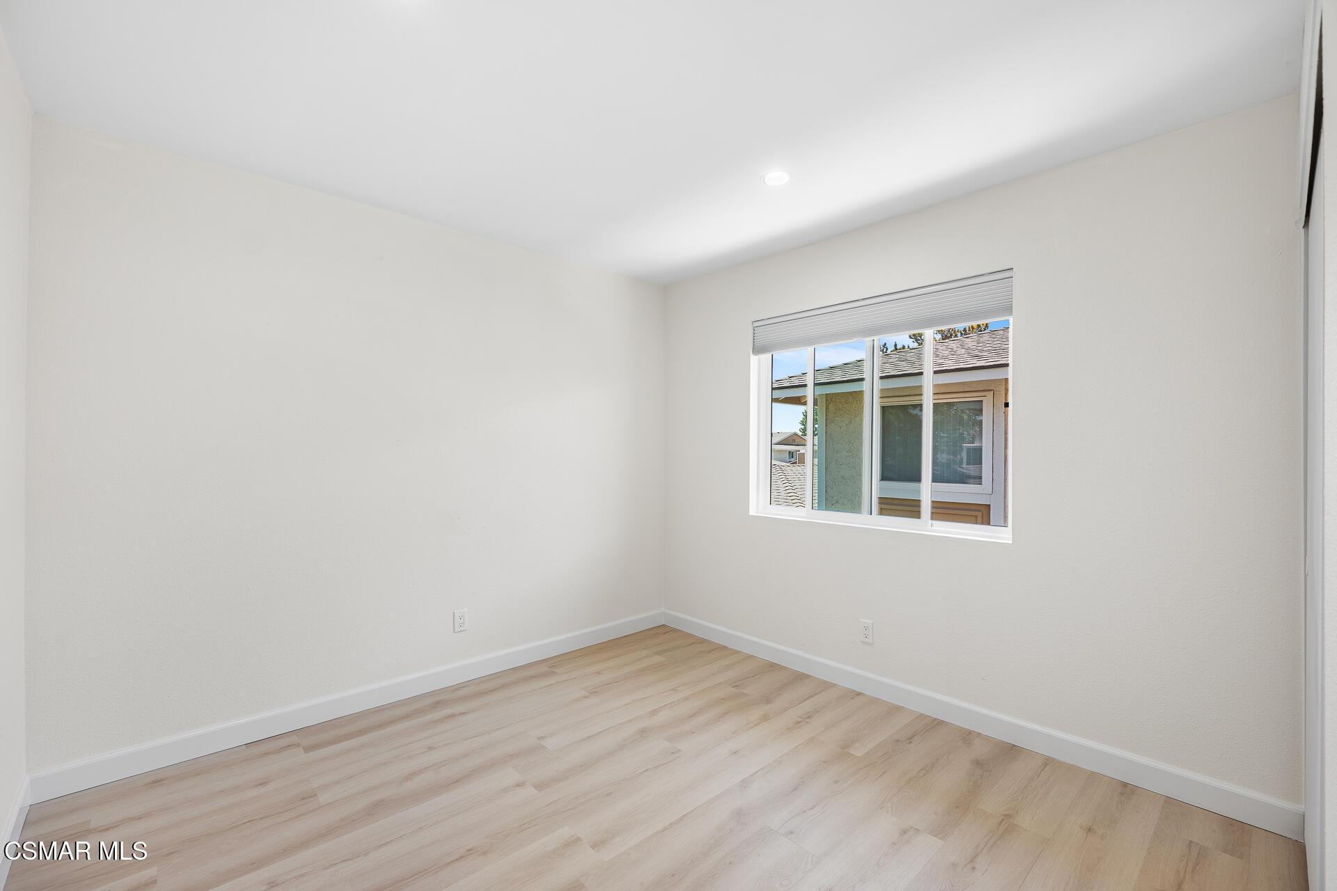 577 Spring Road, Unit 54 Moorpark, CA 93021 - Photo 19 of 23 an empty room with wooden floor and windows