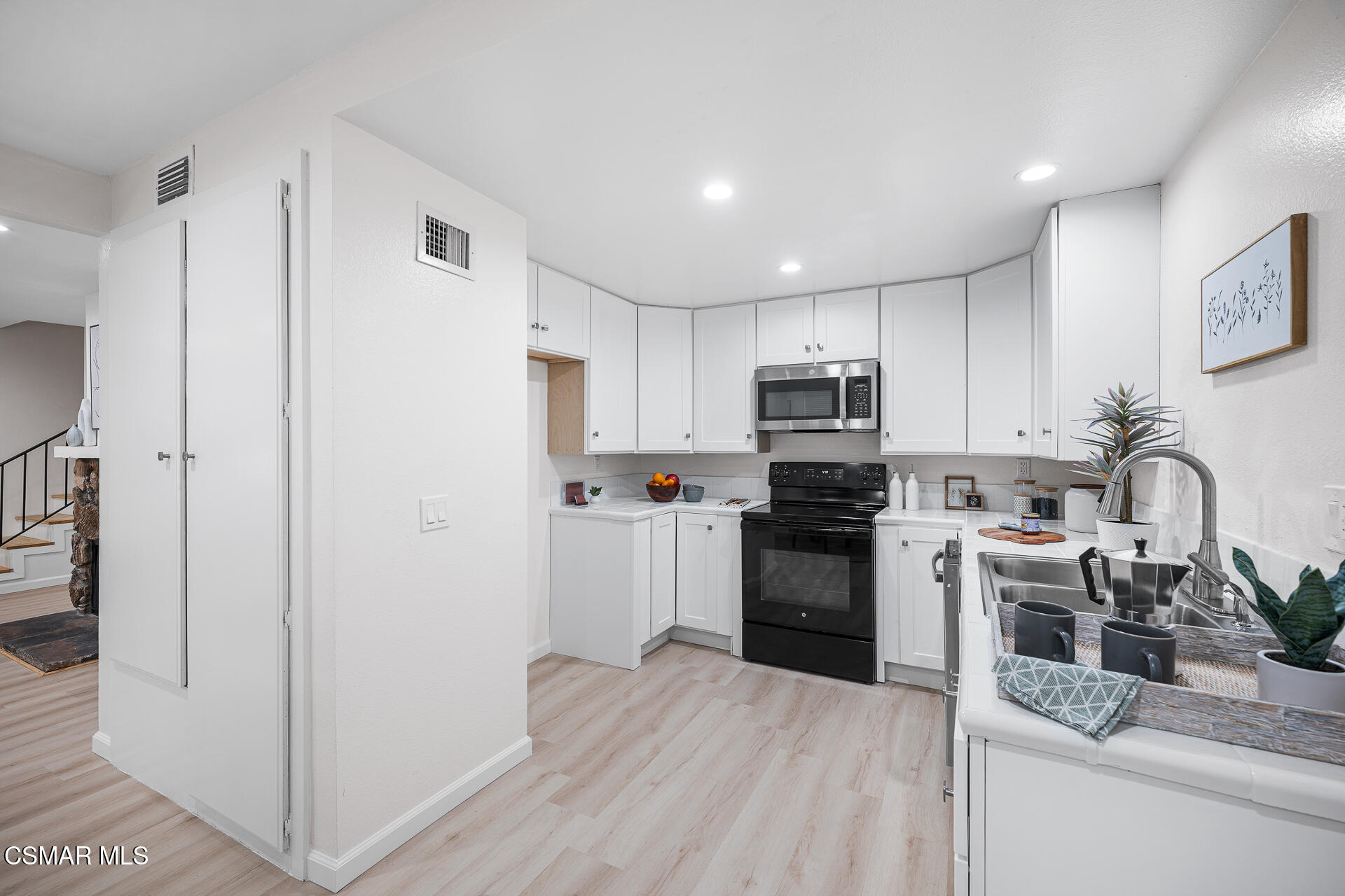 577 Spring Road, Unit 54 Moorpark, CA 93021 - Photo 7 of 23 a kitchen with a refrigerator stove and sink