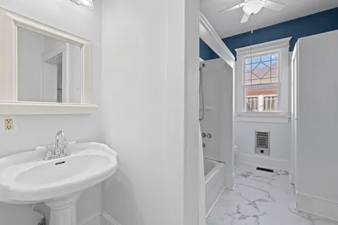 a bathroom with a sink a mirror and a shower