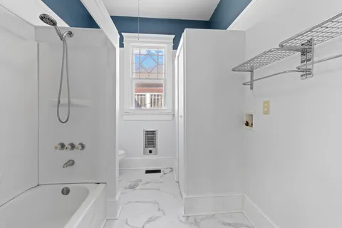 a bathroom with a bathtub and a shower