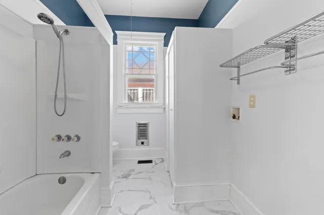 a bathroom with a bathtub and a shower