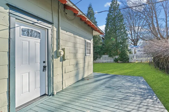 a view of a backyard with wooden fence