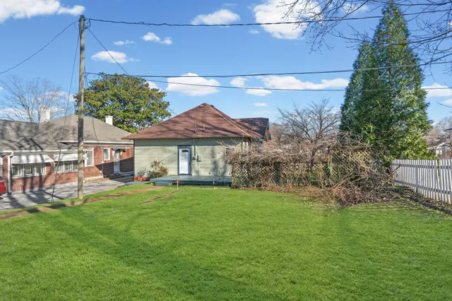 a view of a house with a yard and sitting area