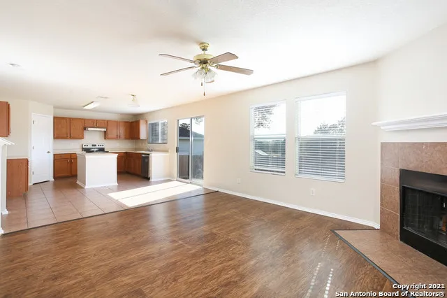 a view of a kitchen with a stove cabinets a refrigerator and a window