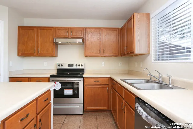a kitchen with a sink stove and cabinets