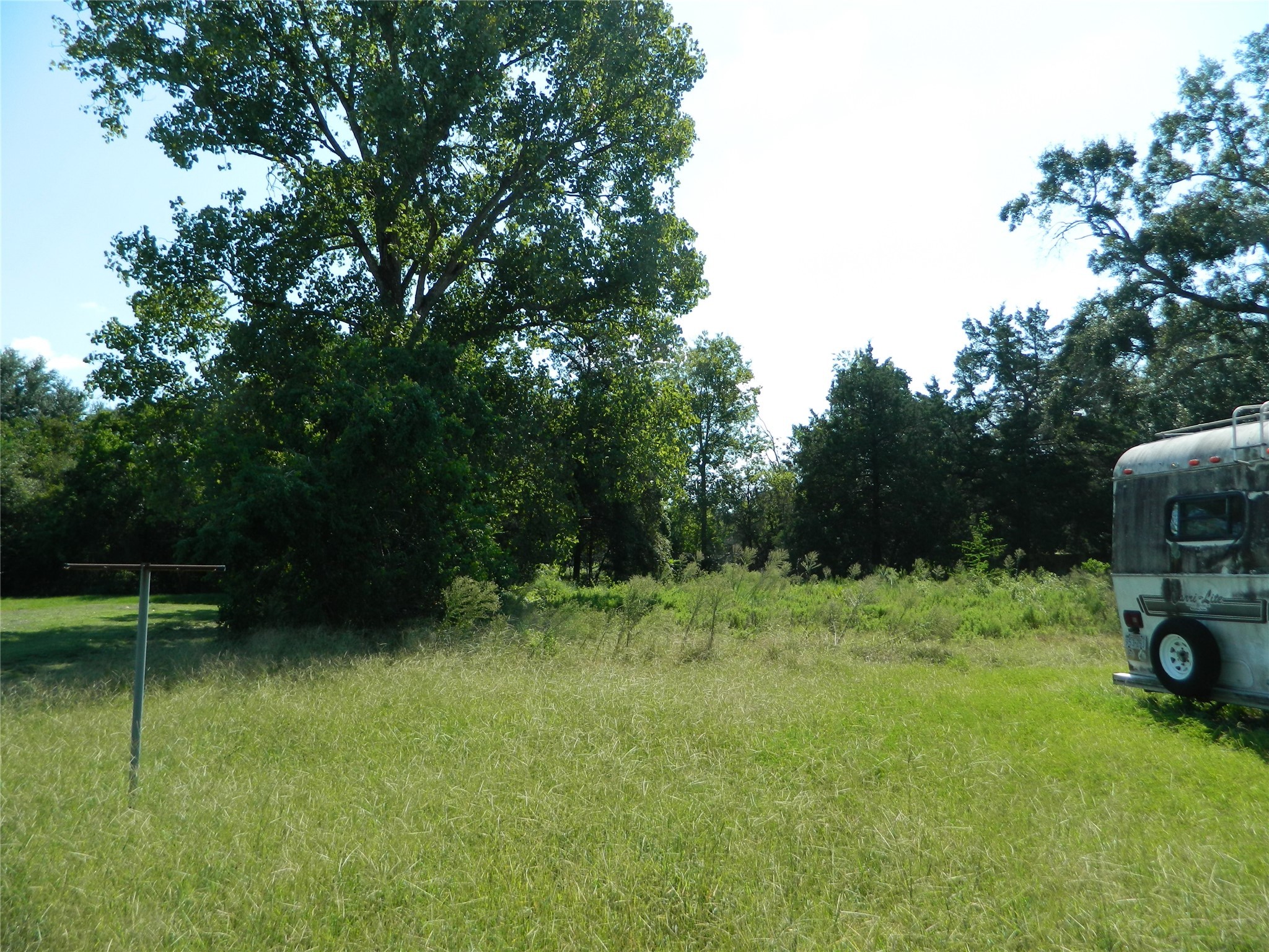 0 None Waller, TX 77484 - Photo 3 of 5 a view of a backyard with a car parked in it