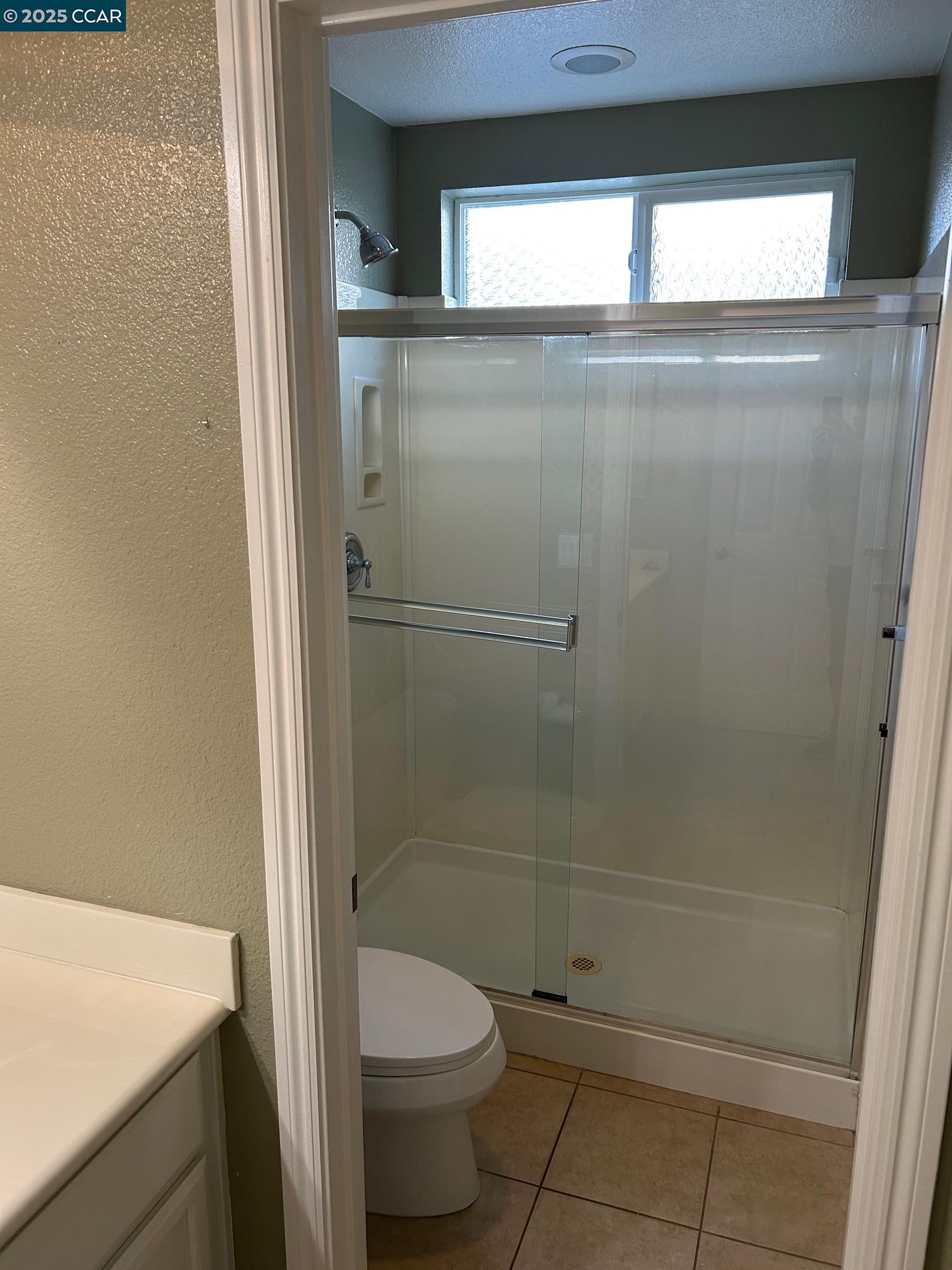 1849 Alexander Way Brentwood, CA 94513 - Photo 13 of 38 a bathroom with a toilet and a shower