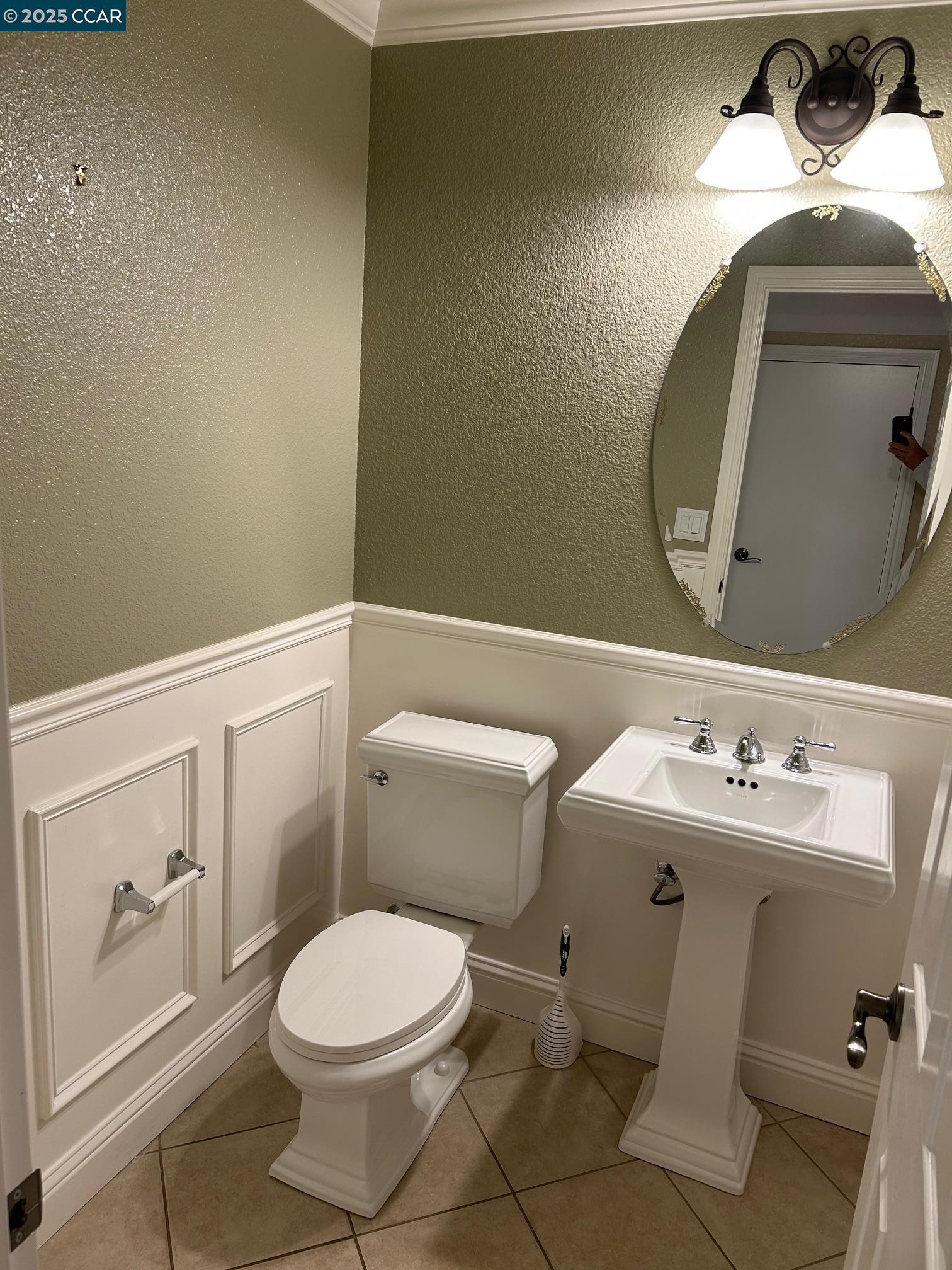 1849 Alexander Way Brentwood, CA 94513 - Photo 15 of 38 a white toilet sitting next to a bathroom sink