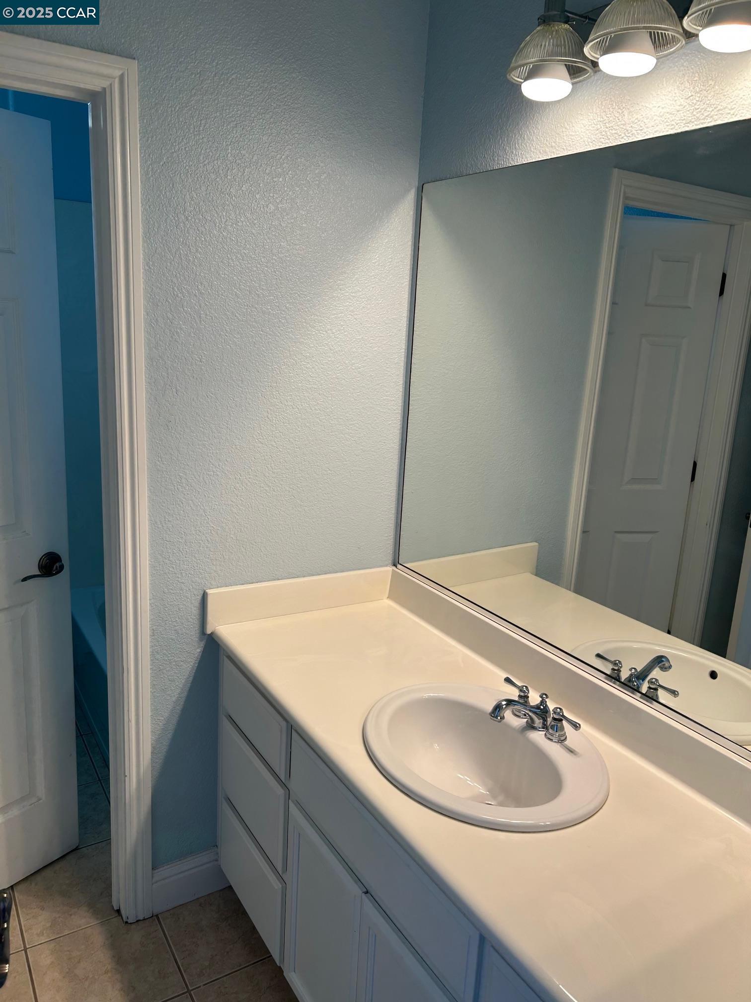 1849 Alexander Way Brentwood, CA 94513 - Photo 24 of 38 a bathroom with a sink and a mirror