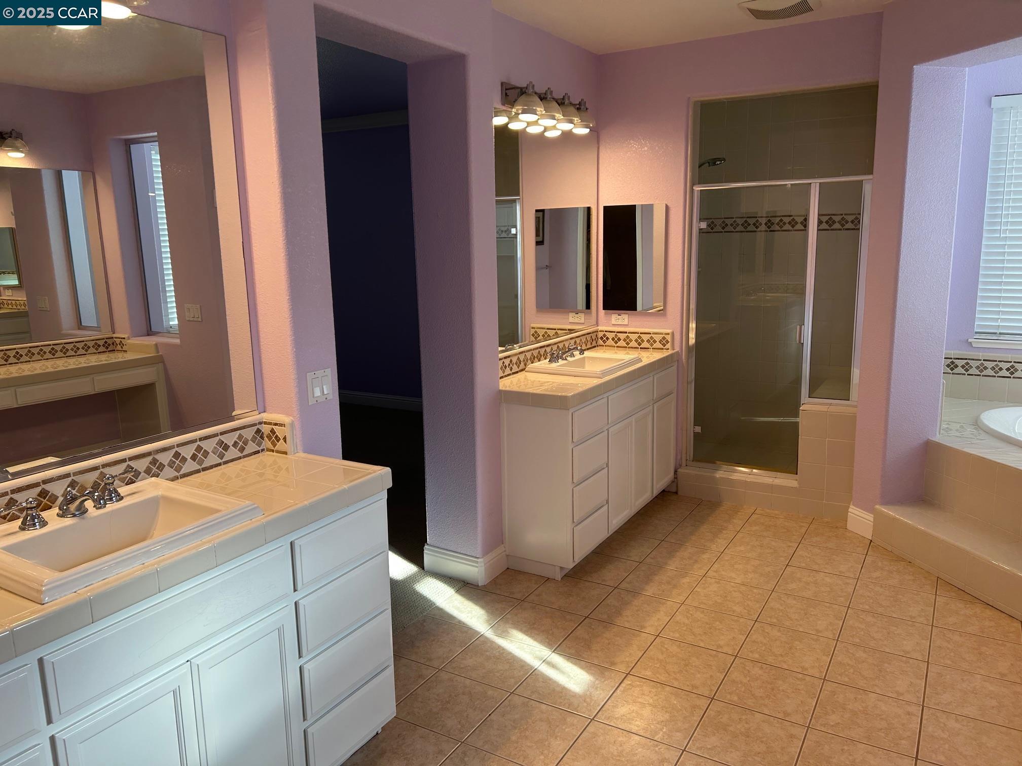 1849 Alexander Way Brentwood, CA 94513 - Photo 30 of 38 a bathroom with a tub sink vanity and mirror