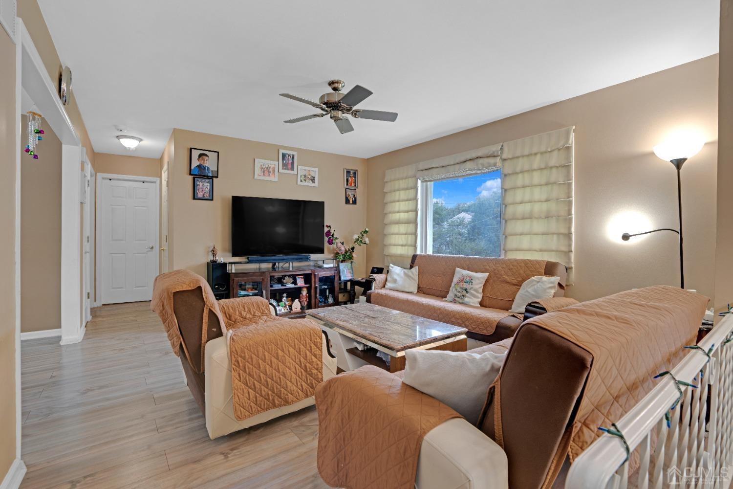 635 Spruce Road North Brunswick, NJ 08902 - Photo 3 of 28 a living room with furniture and a flat screen tv