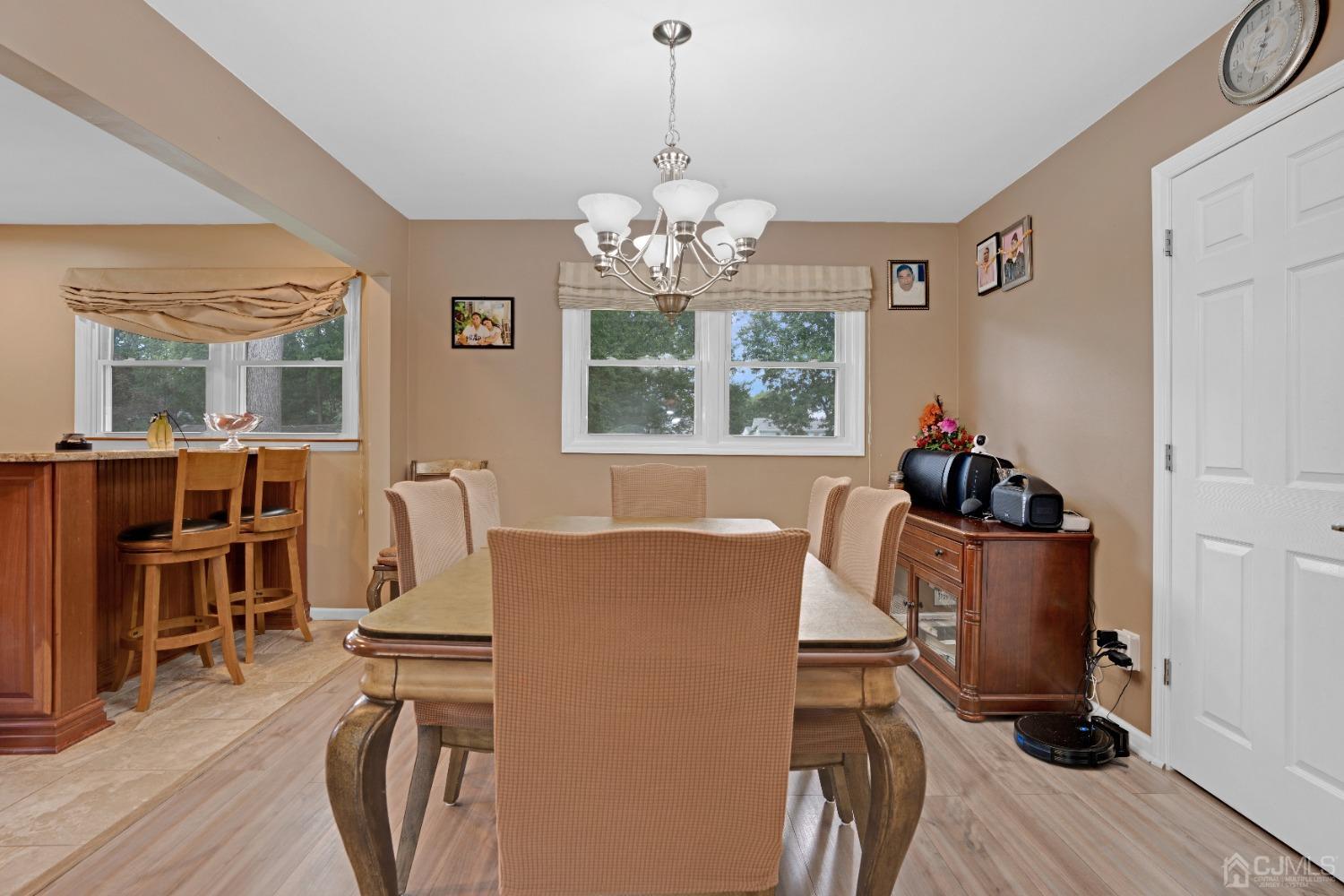 635 Spruce Road North Brunswick, NJ 08902 - Photo 7 of 28 a living room with furniture and a chandelier