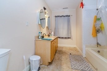 85 Sherman Street, Unit 3 Lowell, MA 01852 - Photo 11 of 11 a bathroom with a sink a toilet and shower