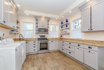 85 Sherman Street, Unit 3 Lowell, MA 01852 - Photo 8 of 11 a kitchen with granite countertop cabinets stainless steel appliances and a sink