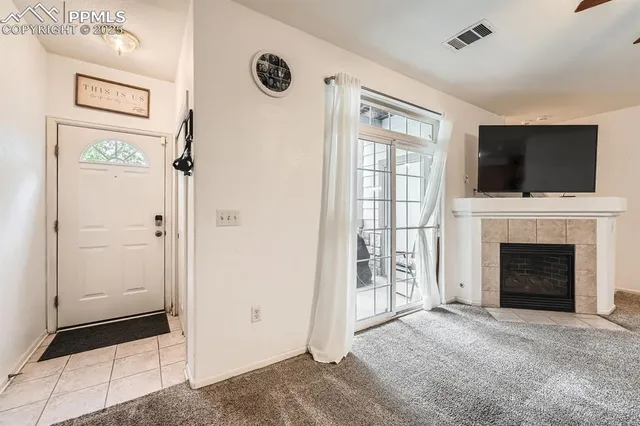 a view of a livingroom with a fireplace cabinet and a flat screen tv