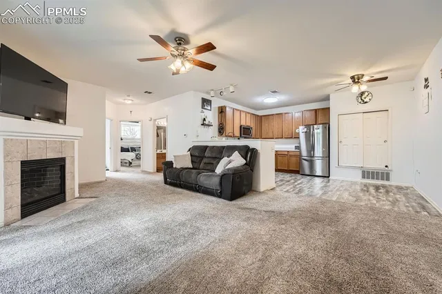a living room with furniture and a fireplace
