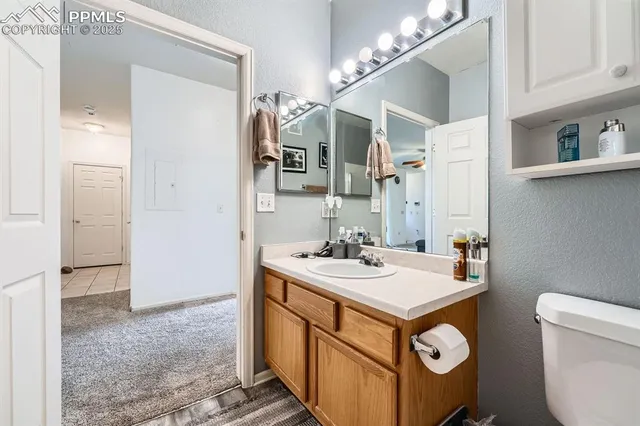 a bathroom with a sink a toilet and mirror