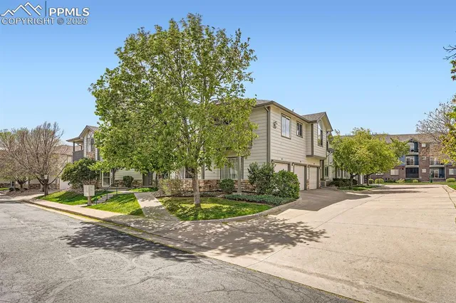 a front view of a house with a yard and trees