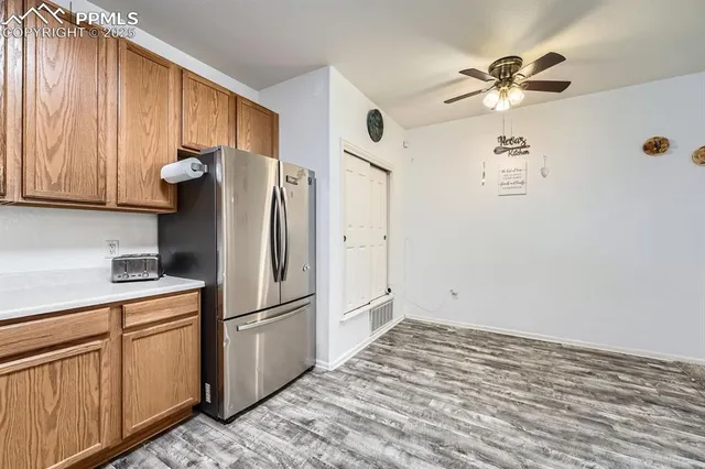 a kitchen with stainless steel appliances a refrigerator sink and cabinets