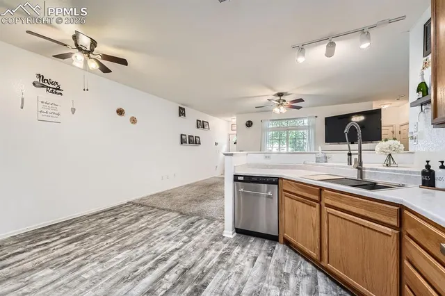 a kitchen with a sink cabinets stainless steel appliances and a window