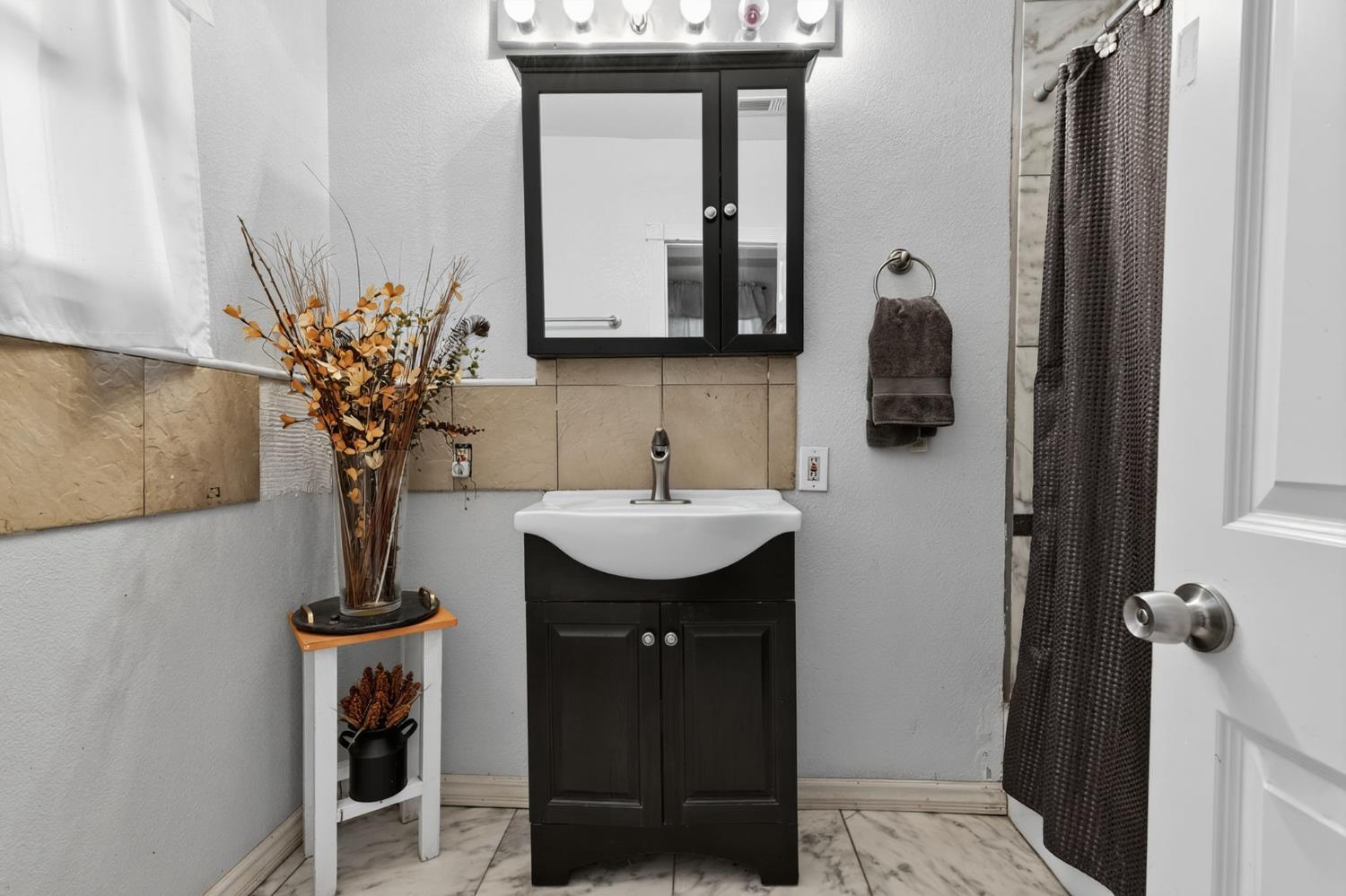 5263 Chile Camp Road Campo Seco X, CA 95226 - Photo 11 of 24 a bathroom with a sink a mirror and a shower