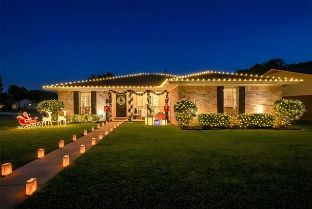 a front view of a house with a garden