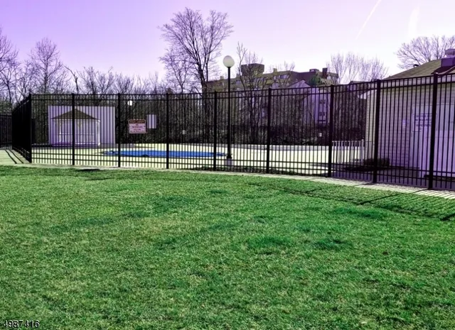 a view of a backyard with a garden and deck